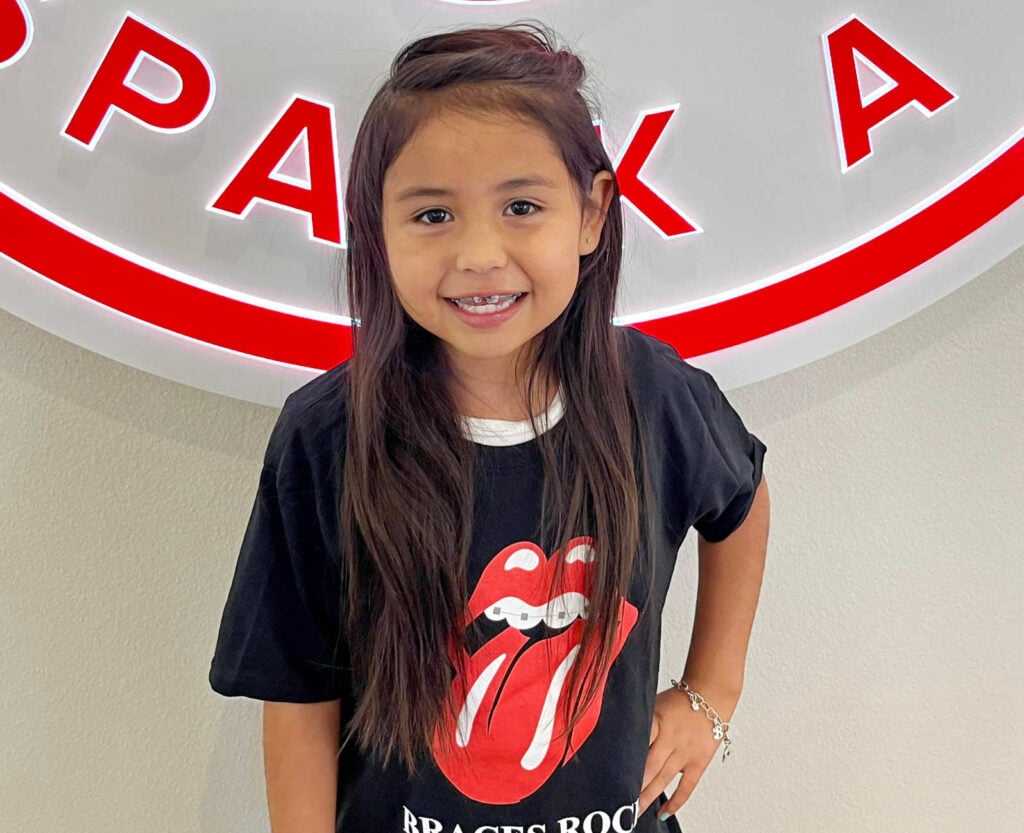 Child wearing braces smiling